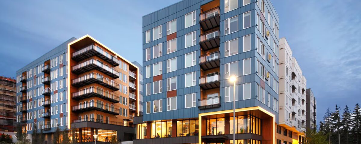Avalon Estera 8 exterior shot during the evening highlighting the custom balconies and railings