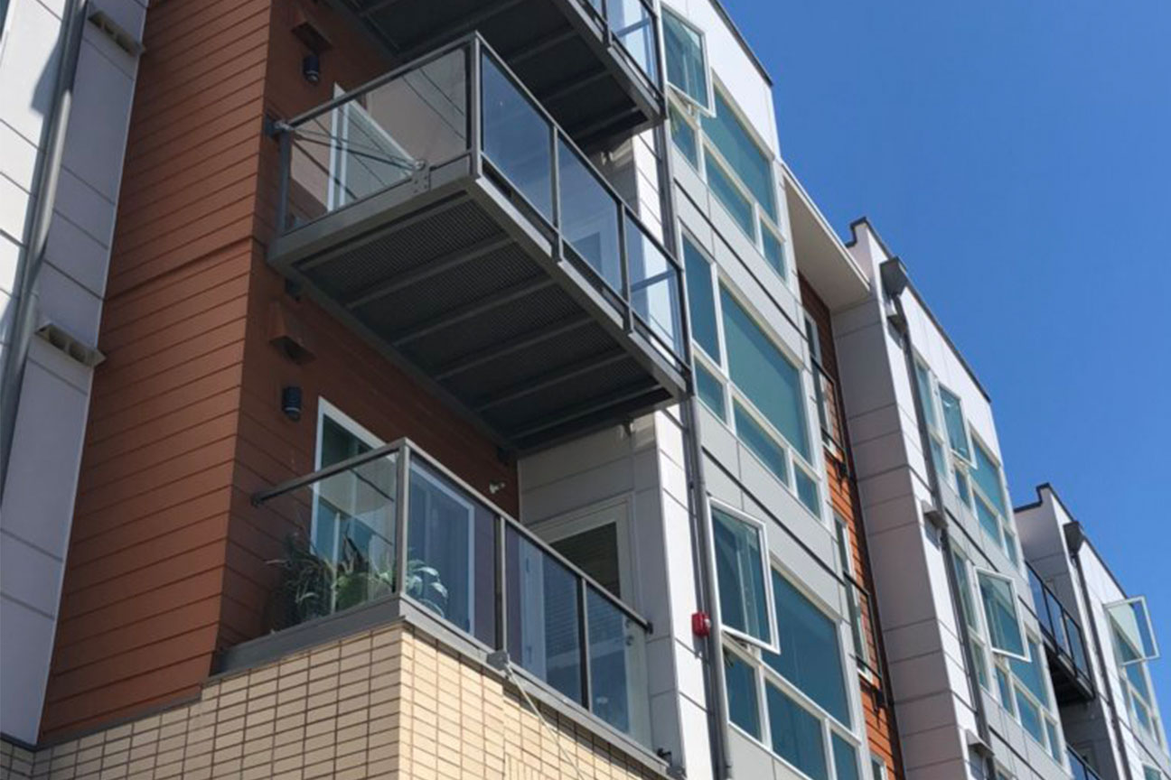 Framed glass single-top railing on a multifamily