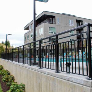 Vertical picket fencing and gate surrounding a pool area