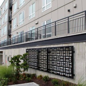 Vertical picket railing on a multifamily complex along with custom metal enclosures