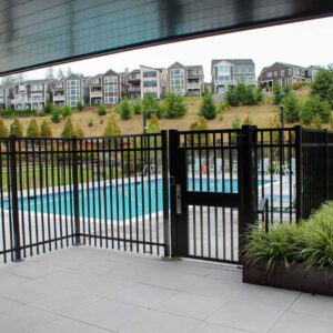 Vertical picket fencing and gate surrounding a pool area