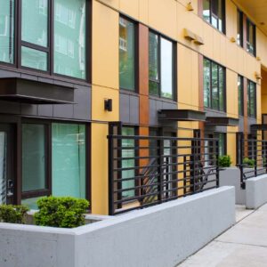 Sun shades and horizontal railings for ground floor units of an apartment complex