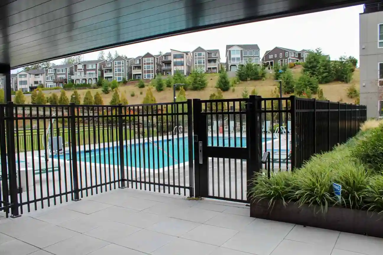 Vertical picket railing enclosure around pool