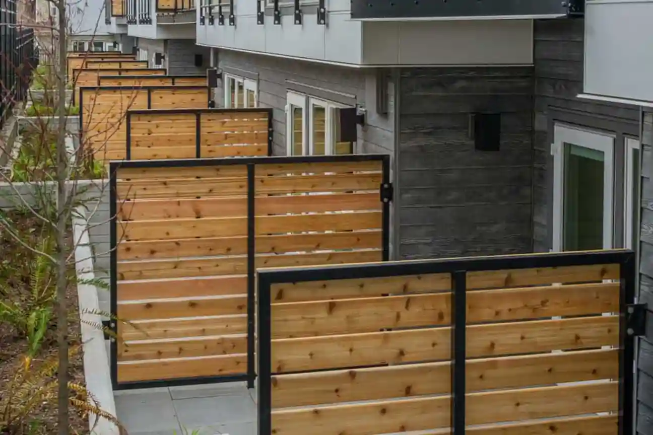Framed fences separating ground floor units of a complex